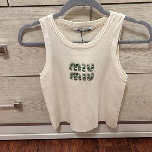 Cream Sleeveless Top with Green Embellished Logo